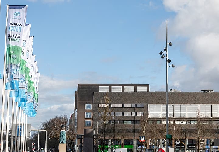 Image of a selection of flags in front of the RAI Convention centre, depicting Gi Aquatech branding.