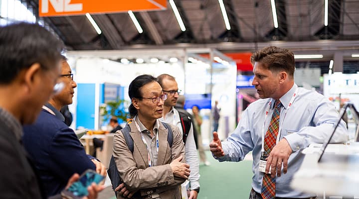 Exhibitor and visitors on the show floor