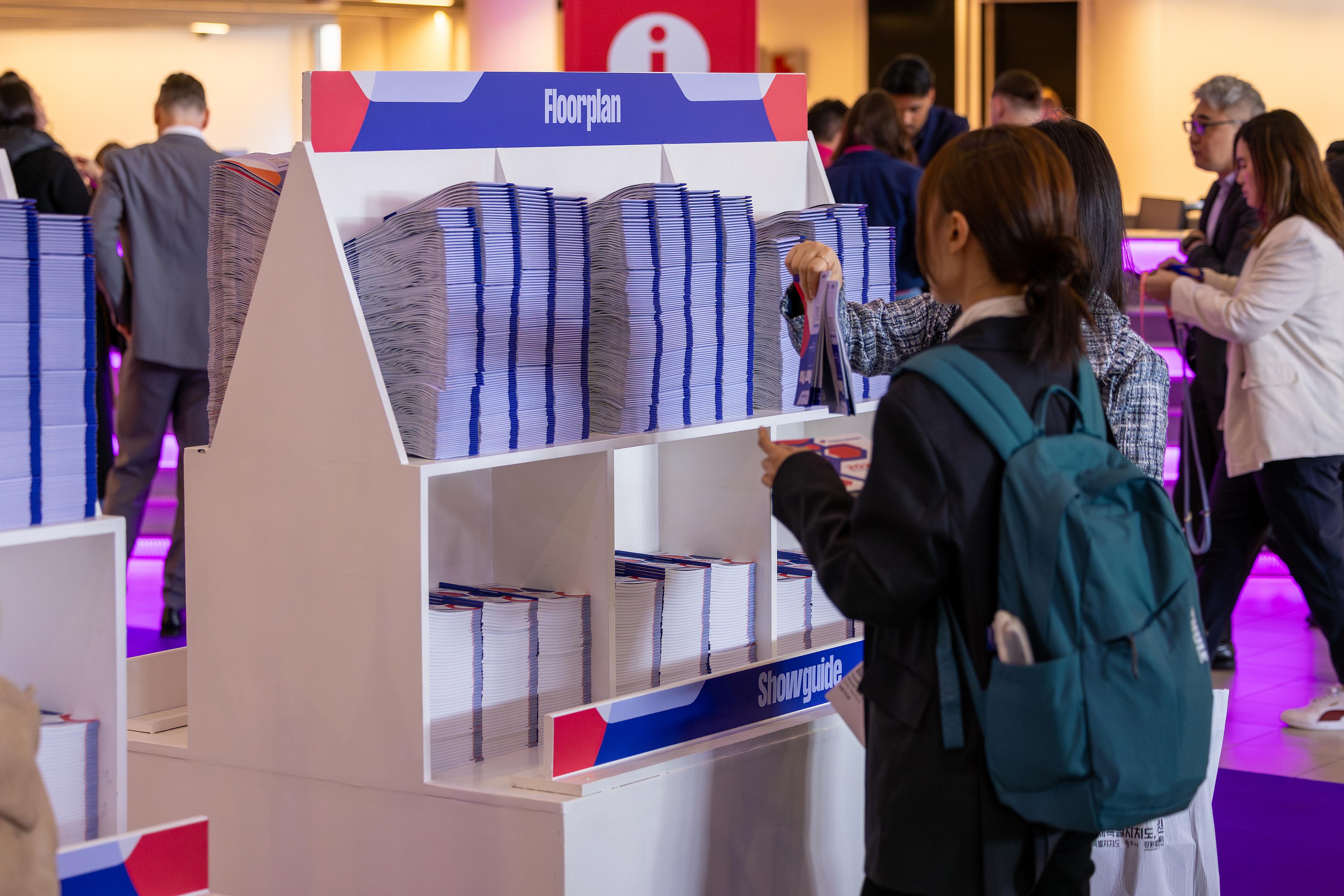 Interclean Amsterdam 2026 visitors picking up a floor plan